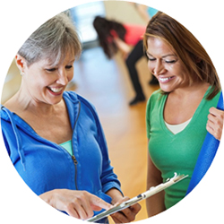 Two women with yoga mats